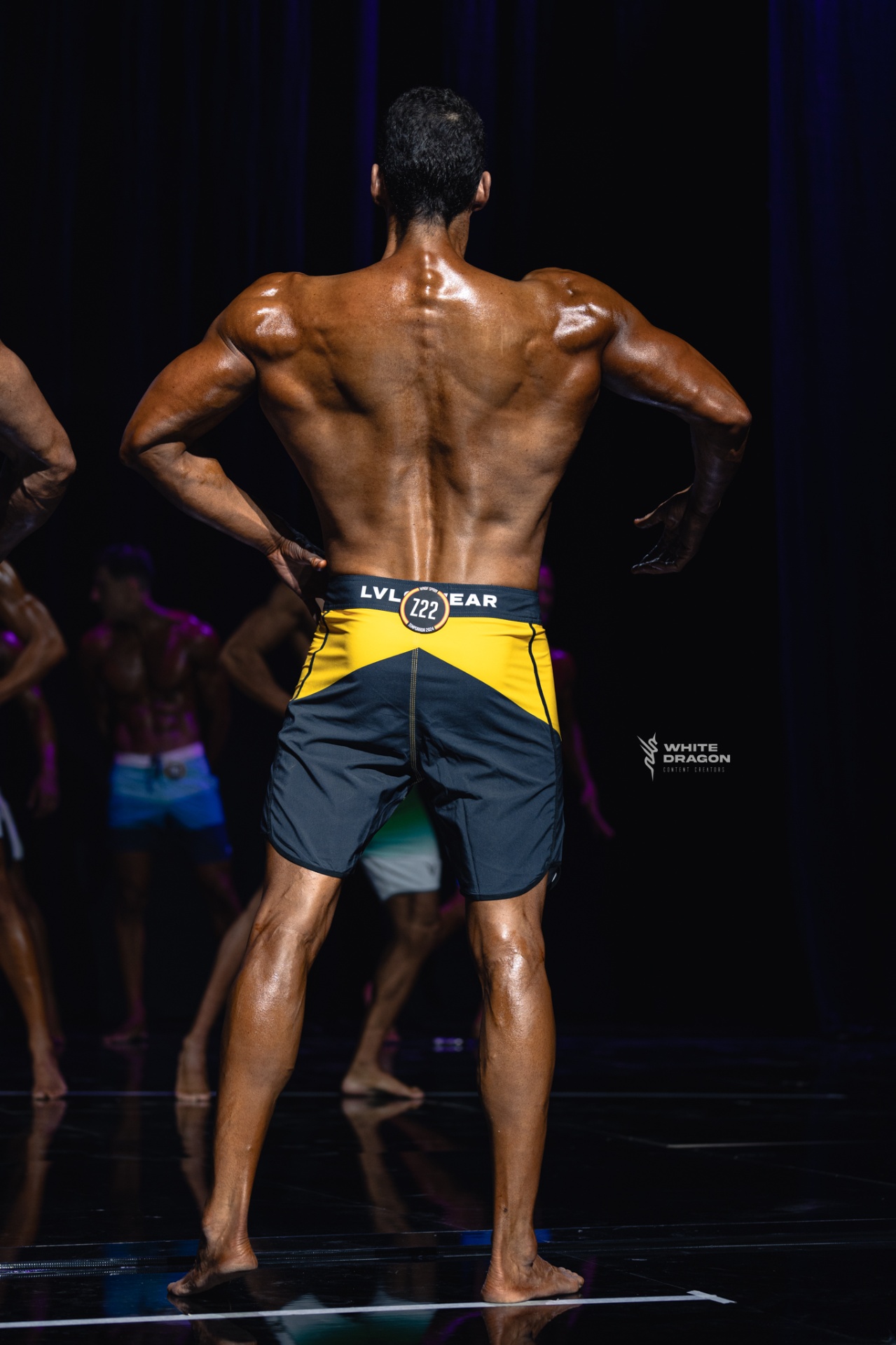 Coach Lou on stage — back pose